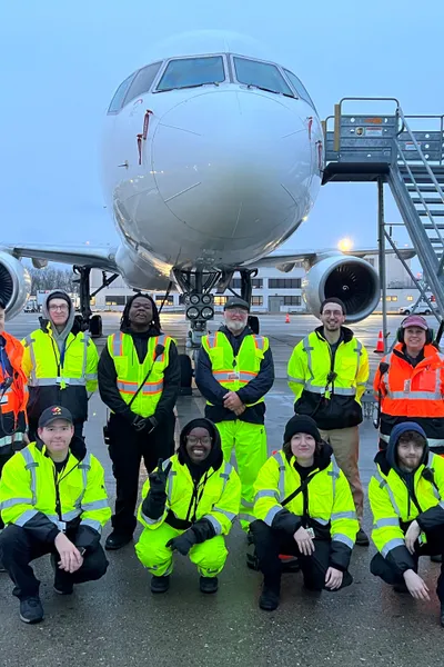 Aircraft on tarmac being serviced by ground handling team